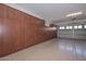 Spacious garage featuring ample cabinet space and a clean, well-maintained epoxy floor at 10039 W Jasmine Trl, Peoria, AZ 85383