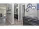 Hallway featuring access to the laundry room and a bathroom at 10039 W Jasmine Trl, Peoria, AZ 85383