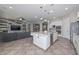 Open concept kitchen with modern appliances, center island, seamlessly connected to the living area at 10039 W Jasmine Trl, Peoria, AZ 85383