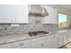 Modern kitchen featuring granite countertops, stainless steel appliances, and a stylish tile backsplash at 10039 W Jasmine Trl, Peoria, AZ 85383