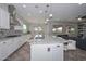 Bright and modern kitchen with stainless steel appliances, center island with granite countertops and seating at 10039 W Jasmine Trl, Peoria, AZ 85383