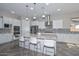 Gourmet kitchen with stainless appliances, granite countertops, and a large center island with barstool seating at 10039 W Jasmine Trl, Peoria, AZ 85383