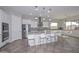 Gourmet kitchen featuring a center island, stainless steel appliances, and adjacent dining area at 10039 W Jasmine Trl, Peoria, AZ 85383