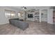 Cozy living room with large sectional, TV, and view of the covered patio and backyard at 10039 W Jasmine Trl, Peoria, AZ 85383