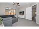 Living room featuring large windows, ceiling fan and TV at 10039 W Jasmine Trl, Peoria, AZ 85383