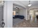 Spacious living room with neutral decor, a plush blue sofa, and modern ceiling fan at 10039 W Jasmine Trl, Peoria, AZ 85383