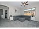 Relaxing living room showcasing neutral tones, a comfortable gray sectional, and a ceiling fan for added comfort at 10039 W Jasmine Trl, Peoria, AZ 85383