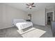 Large main bedroom with neutral walls, ceiling fan and adjoining bathroom at 10039 W Jasmine Trl, Peoria, AZ 85383