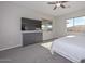 Main bedroom featuring a comfortable bed, large TV, and dual pane windows at 10039 W Jasmine Trl, Peoria, AZ 85383
