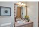 Bathroom with a large framed mirror, decorative tile, and a white toilet at 10040 E Happy Valley Rd # 249, Scottsdale, AZ 85255