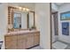 Bathroom featuring a sink, mirror, and view of the shower through the doorway at 10040 E Happy Valley Rd # 249, Scottsdale, AZ 85255