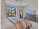 Bright bedroom features a view of the garden through a large window, plus a dresser and a TV at 10040 E Happy Valley Rd # 249, Scottsdale, AZ 85255