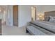 Comfortable bedroom featuring a large cozy bed and doors to the bathroom and hallway at 10040 E Happy Valley Rd # 249, Scottsdale, AZ 85255