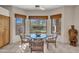 Cozy breakfast nook with a round table and chairs next to windows with view of the flowering garden at 10040 E Happy Valley Rd # 249, Scottsdale, AZ 85255