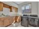 Functional laundry room with modern washer and dryer units and ample cabinet space at 10040 E Happy Valley Rd # 249, Scottsdale, AZ 85255