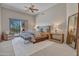 Relaxing bedroom with a king size bed, fireplace and glass door to the outdoor view at 10040 E Happy Valley Rd # 249, Scottsdale, AZ 85255