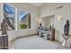 Bright sitting room with shuttered windows, a console table, and stylish lighting at 10040 E Happy Valley Rd # 249, Scottsdale, AZ 85255