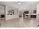 Bright open-concept living area with tile floors flowing into kitchen with an island and bar stool seating at 10511 W Villa Hermosa --, Peoria, AZ 85383