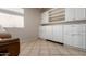 Living area with white cabinets and shelves on one wall and tile flooring at 10511 W Villa Hermosa --, Peoria, AZ 85383