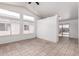 Bright living room with tile floors, large windows, and a neutral color palette at 10541 W Pasadena Ave, Glendale, AZ 85307