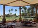 Relax in the shade with views of the golf course under the pergola-covered outdoor dining area at 10617 E Michigan Ave, Sun Lakes, AZ 85248