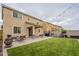 Backyard featuring a covered patio, artificial turf, barbeque, and string lights at 10822 W Taylor St, Avondale, AZ 85323