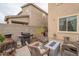 Backyard features a grill and wicker furniture around a blue glass fire pit at 10822 W Taylor St, Avondale, AZ 85323