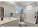 Bathroom featuring a shower-tub combo with a striped shower curtain and a single sink vanity at 10822 W Taylor St, Avondale, AZ 85323