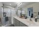 Bright primary bathroom featuring a double sink vanity, a glass shower enclosure, and modern fixtures at 10822 W Taylor St, Avondale, AZ 85323