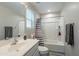 Bright bathroom features a shower-tub combination, neutral color palette, and a large vanity mirror at 10822 W Taylor St, Avondale, AZ 85323