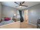 Comfortable bedroom features carpet, a ceiling fan, and light gray walls at 10822 W Taylor St, Avondale, AZ 85323