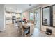Dining area with wood-look tile, white cabinets, stainless steel appliances, and sliding door at 10822 W Taylor St, Avondale, AZ 85323