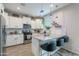 Well-lit kitchen with white cabinets, granite countertops, and stainless steel appliances at 10822 W Taylor St, Avondale, AZ 85323