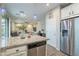 Modern kitchen with stainless steel appliances, island, and open layout to living spaces at 10822 W Taylor St, Avondale, AZ 85323