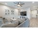 Comfortable living room featuring a large sectional couch, neutral tones, and ample natural light at 10822 W Taylor St, Avondale, AZ 85323