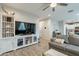 Cozy living room featuring a TV, built-in shelving, and a comfortable seating arrangement at 10822 W Taylor St, Avondale, AZ 85323