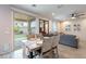 Open living space with dining table, grey sofa, and sliding glass doors to backyard at 10822 W Taylor St, Avondale, AZ 85323