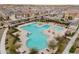 Aerial view of a community pool with lounge seating and covered shade at 10822 W Taylor St, Avondale, AZ 85323