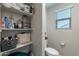 This toilet room provides privacy and features shelving with linens and storage at 10822 W Taylor St, Avondale, AZ 85323
