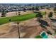 This is an aerial view of a meticulously maintained golf course with an adjacent swimming pool at 11025 N Madison Dr, Sun City, AZ 85351