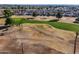 Aerial view of a lush golf course with mature trees and green fairways at 11025 N Madison Dr, Sun City, AZ 85351