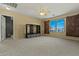 Large carpeted bedroom featuring a ceiling fan and decorative barn door window coverings at 14104 N 146Th Ln, Surprise, AZ 85379