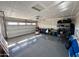 Spacious garage with overhead door, storage shelves, and epoxy flooring at 1418 E Peggy Dr, Casa Grande, AZ 85122