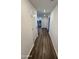 Hallway with wood grain flooring leading towards the kitchen and living area at 1418 E Peggy Dr, Casa Grande, AZ 85122