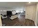 Open-concept living room with wood grain floors connecting living, dining, and kitchen at 1418 E Peggy Dr, Casa Grande, AZ 85122