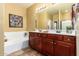 Bathroom featuring double sink vanity and a tub at 1422 S Colt Dr, Gilbert, AZ 85296