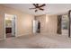 Bright bedroom with a ceiling fan, ensuite bathroom, and carpet flooring at 1422 S Colt Dr, Gilbert, AZ 85296