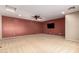 Spacious bonus room features a ceiling fan, neutral carpet and paint, and a mounted TV at 1422 S Colt Dr, Gilbert, AZ 85296