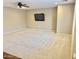 Spacious bonus room with wall-mounted television, ceiling fan, and plush carpeting at 1422 S Colt Dr, Gilbert, AZ 85296