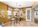Charming breakfast nook with a glass table, decorative chandelier, and bright natural light at 1422 S Colt Dr, Gilbert, AZ 85296